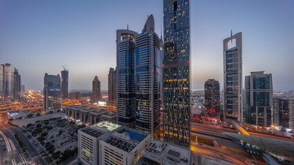Fototapeta na wymiar Aerial view of Dubai International Financial District with many skyscrapers day to night .