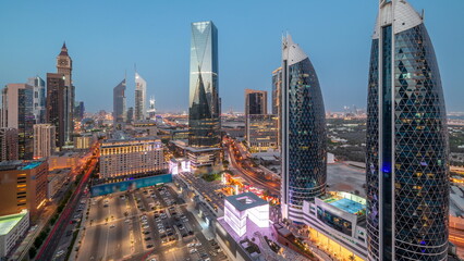Fototapeta na wymiar Aerial view of Dubai International Financial District with many skyscrapers day to night .