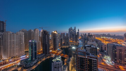Fototapeta na wymiar Panorama of various skyscrapers in tallest recidential block in Dubai Marina aerial night to day