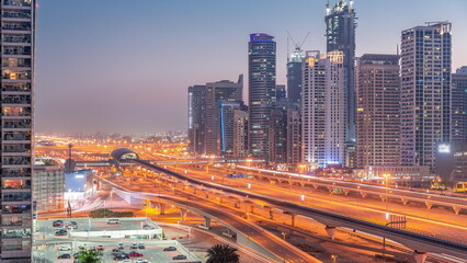 Fototapeta na wymiar Dubai Marina skyscrapers and Sheikh Zayed road with metro railway aerial day to night , United Arab Emirates