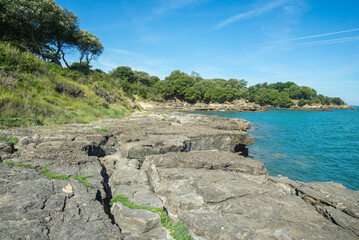 Rocky coastline and turquoise ocean at island Ile d'Aix, Charente Maritime, west Atlantic coast...