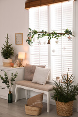 Beautiful room interior decorated for Christmas with potted firs