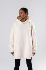 Attractive african american woman in oversized white hoodie. Mock-up.