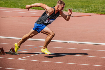athlete runner running sprint in starting blocks