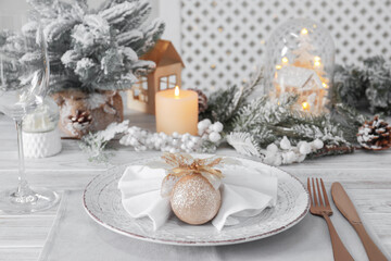 Festive place setting with beautiful dishware, cutlery and decor for Christmas dinner on white wooden table