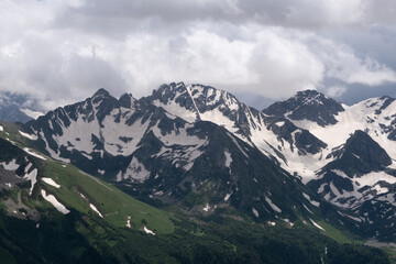 Fototapeta na wymiar snow on mountain peak in summer in arkhyz