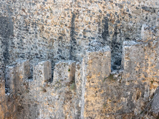 Stone wall with battlements of the old fortress of the city of Alanya, Turkey