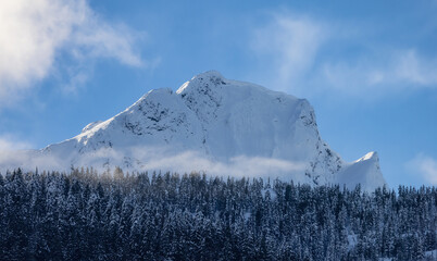 Snow and Cloud covered Canadian Nature Landscape Background. Winter Season in Squamish, British Columbia, Canada. Sunny Sky