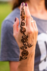Close up shot of a beautiful woman's hand with nail polish and henna design. Beauty