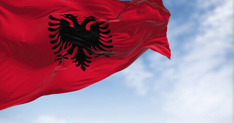 Close-up view of the Albanian national flag waving in the wind - obrazy, fototapety, plakaty