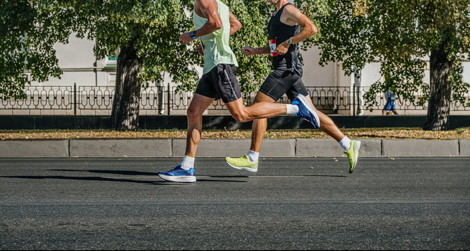 two male athlete running city marathon