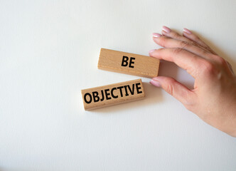 Be Objective symbol. Wooden blocks with words Be Objective. Businessman hand. Beautiful white background. Business and Be Objective concept. Copy space.