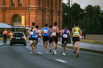 leading group of runners run city marathon