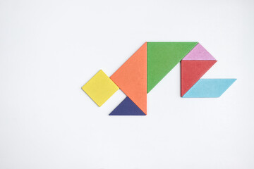 color tangram puzzle in kneel down shape on white background