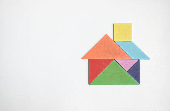color wood tangram puzzle in house shape on white background