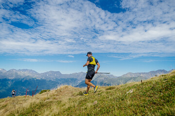 male runner running mountain trail race