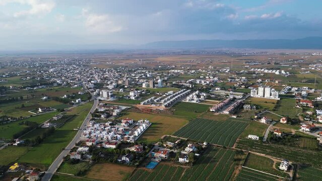 Northern Cyprus. Drone video. A beautiful area of Cyprus. Buildings, fields and the sea from a bird's eye view. Beautiful landscape. City life. A tourist place. Lots of greenery. 