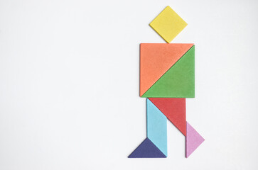 color tangram puzzle in walking man shape on white background