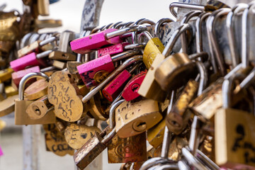 Love locks line the railings of the Debilly Footbridge, a pedestrian bridge crossing the Seine river.