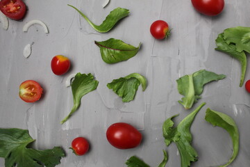 the background of a meal of tomato vegetables on a gray background. Tomatoes salad onions on a gray background. Diet