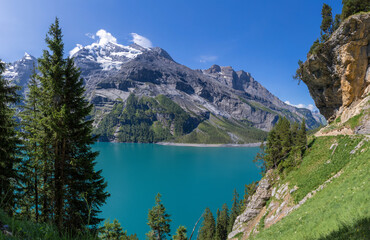Fototapeta na wymiar The Oeschinensee lake and the peaks Doldenhorn, Frundenhorn, Oeschinenhorn in Bernese alps.