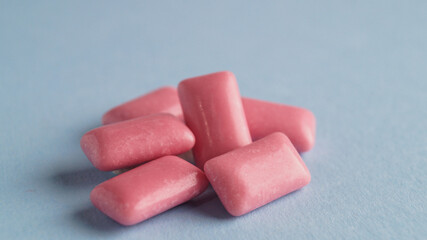 Heap of tasty sweet chewing gums on light blue background