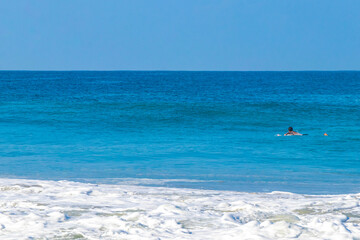 Fototapeta na wymiar Surfer surfing on surfboard on high waves in Puerto Escondido Mexico.