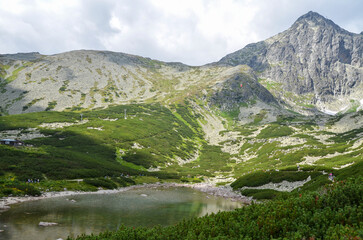Naklejka na ściany i meble Summer nature landscape with one of the most famous mountain lakes in the Slovakian Tatra Mountains, Skalnate Pleso (Rocky Tarn) and Lomnicky peak on background