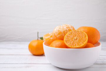 Fresh juicy tangerines on white wooden table, space for text