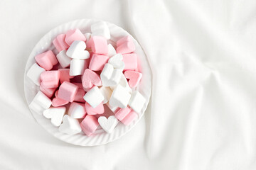 Pink and white marshmallows heart shape. Fluffy sweets for love theme or Valentine concept in...