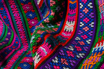 Handmade textile detail made by Guatemalan artisan in Central America, colorful detail full of tradition and culture, colonial history, Mayan cosmovision. 