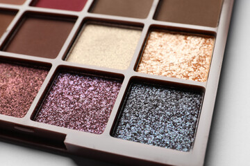 Beautiful eye shadow palette on white table, closeup