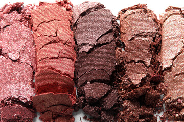 Different crushed eye shadows on white background, closeup. Professional makeup product