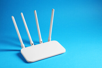 New white Wi-Fi router on blue background, space for text