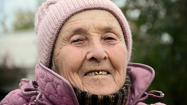Grandma smiles. The face of an old grandmother. Old face close up. Elderly woman. Old grandmother. War in Ukraine. Wrinkles on the face of an old grandmother. Wrinkled face close-up. Ukrainian woman.