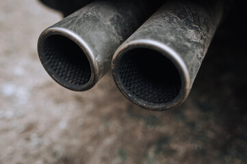 Two exhaust pipes of a sports car close-up.