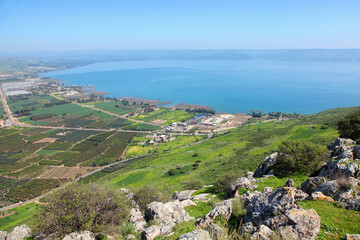 Agriculture valley panoramic landscape with Kineret lake and recreation area view from the top of Arbel Cliff. Nature and Mountain. Arbel National park. Nature reserve. Low Galilee, Israel