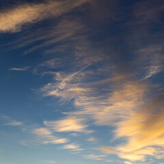 blue sky with golden clouds beautifully illuminated by the sun as a natural background