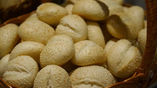 small wheat buns with sesame seeds in a basket