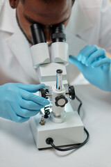 Researcher working with microscope in medical office