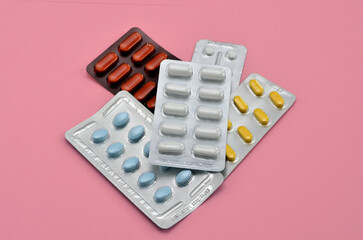 a pile of pills on a pink background