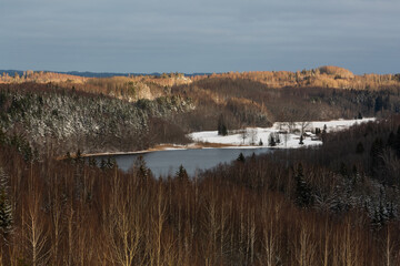 sunny snowy winter day in the countryside with lake