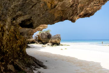 Zelfklevend Fotobehang Landscape of the Indian Ocean coastline with at Mtende Beach, Zanzibar. Rocks and white sand. View from the sea © Sebastian