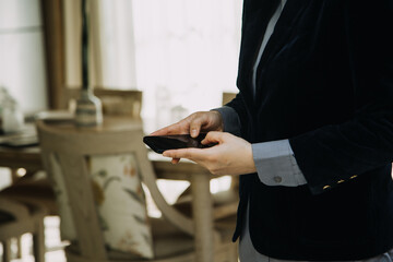 Mature businessman using a digital tablet to discuss information with a younger colleague in a modern business lounge