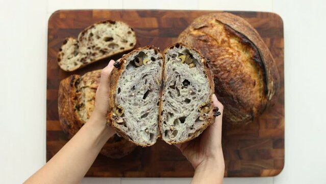 Artisan bread. Homemade Sourdough bread with olives. Top view showing cut bread on cutting board