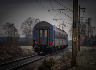 Obraz premium Passenger electric train in frosty cloudy morning near station Donov 01 30 2023
