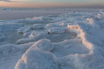Wonderfully beautiful sunset by the sea in winter with ice