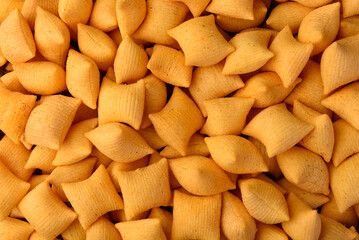 Salty bacon chips background or texture.