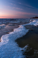 Wonderfully beautiful sunset by the sea in winter with ice