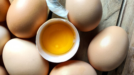 Fresh chicken eggs are collected in a pile. A broken egg. - 566753302